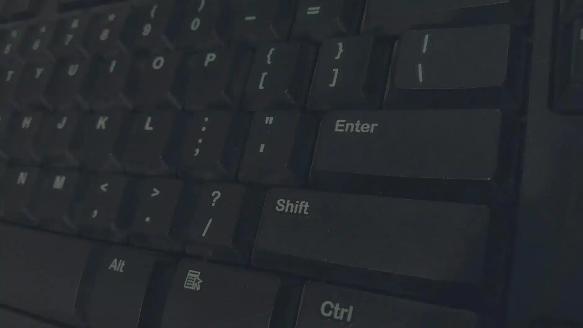 Close-up of a computer keyboard showing Enter and Shift keys.