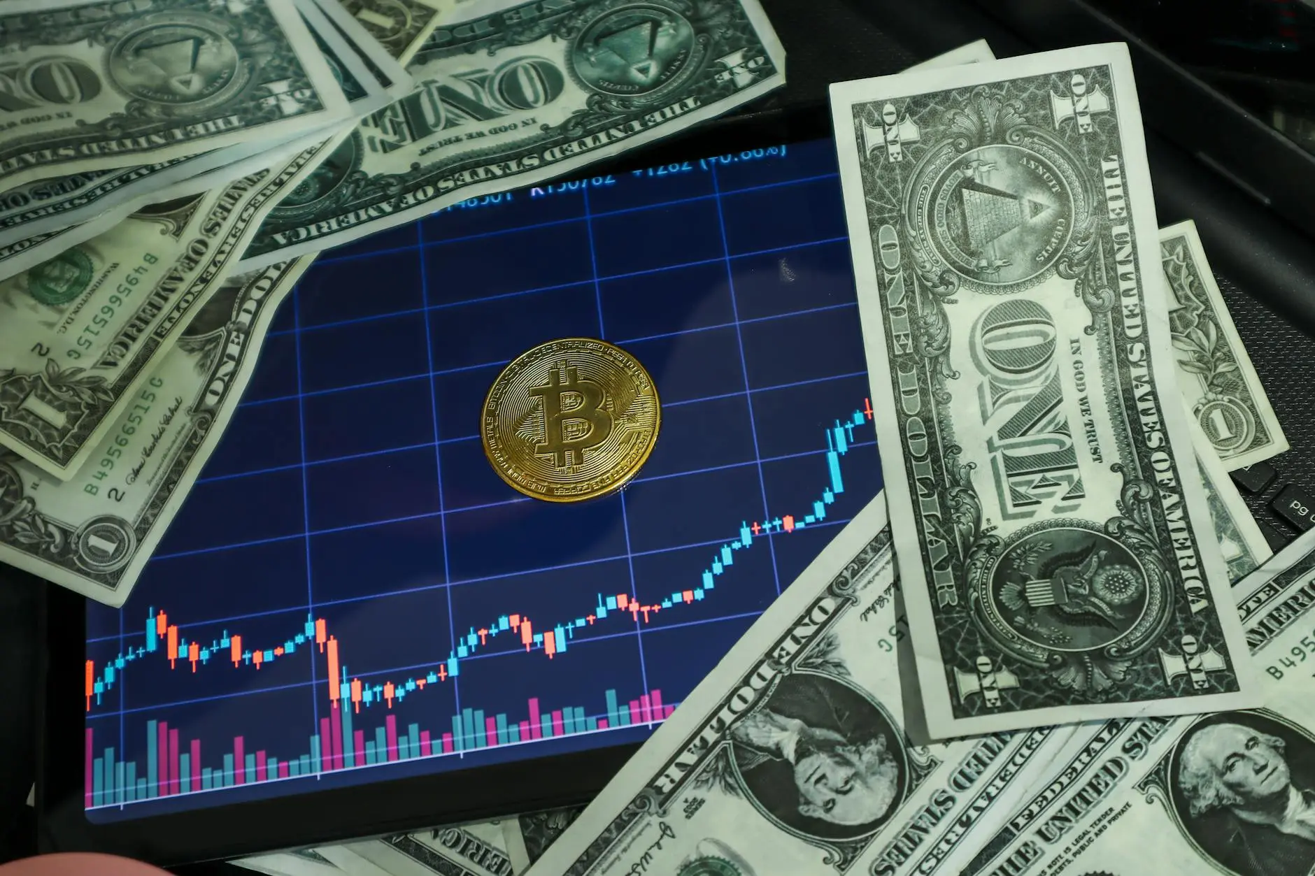 Bitcoin coin on a stock chart surrounded by dollar bills.