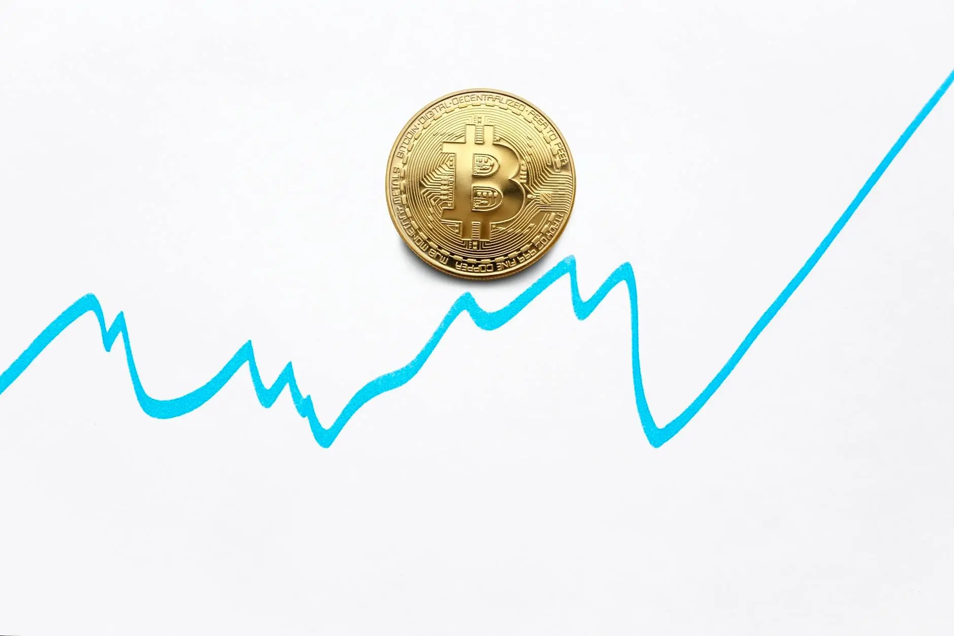 Bitcoin coin on a white background with a blue growth chart line.
