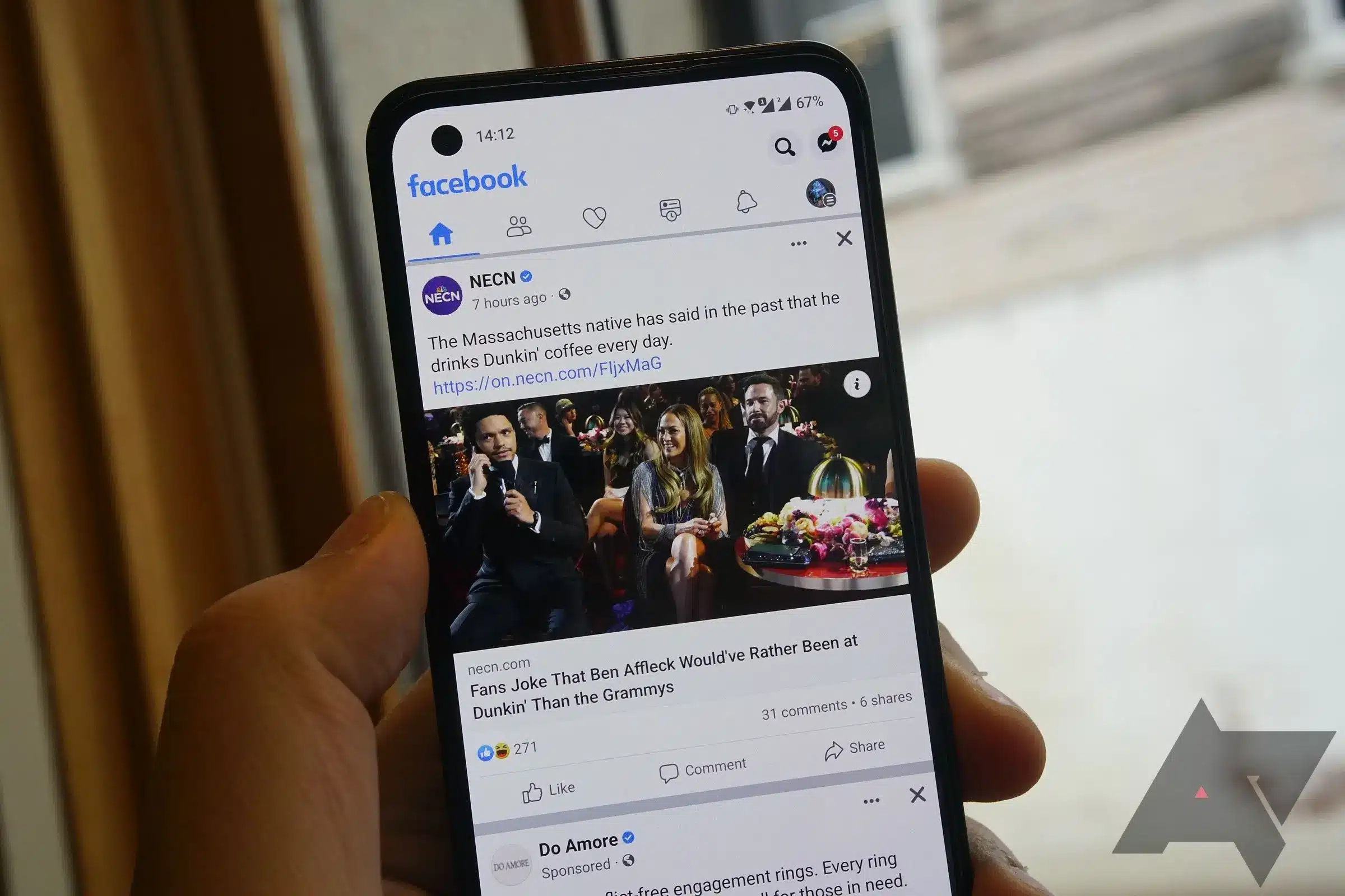 Facebook mobile app displaying a news feed on a smartphone.