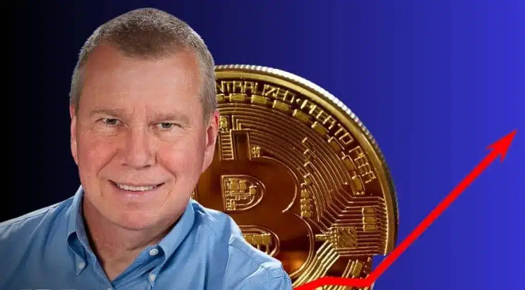 Smiling man in a blue shirt beside a Bitcoin coin and an upward trend arrow.