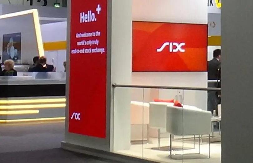 Display featuring SIX Digital Exchange logo and welcome message at an exhibition.
