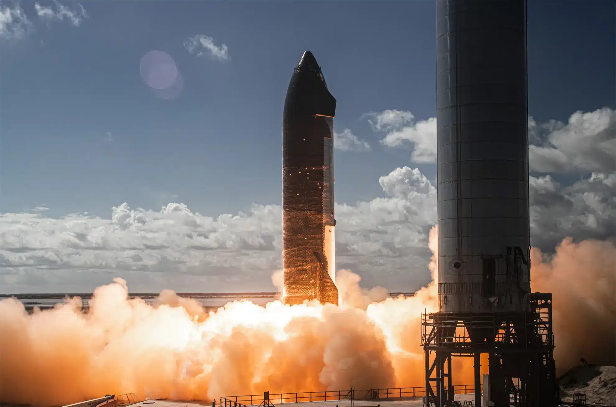 SpaceX Starship rocket launching with visible smoke and flames.