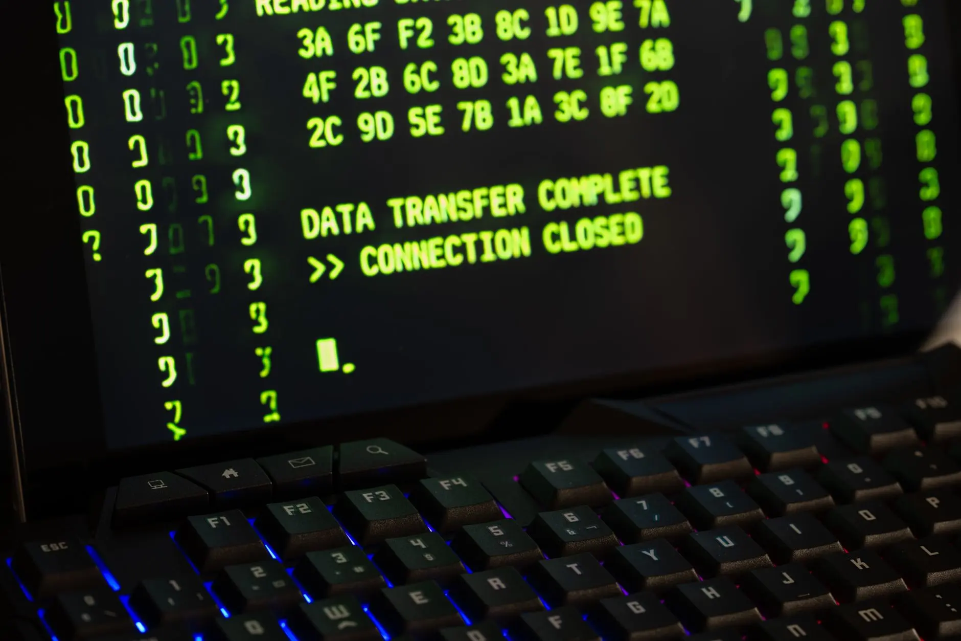 Close-up of computer screen displaying code and data transfer messages.