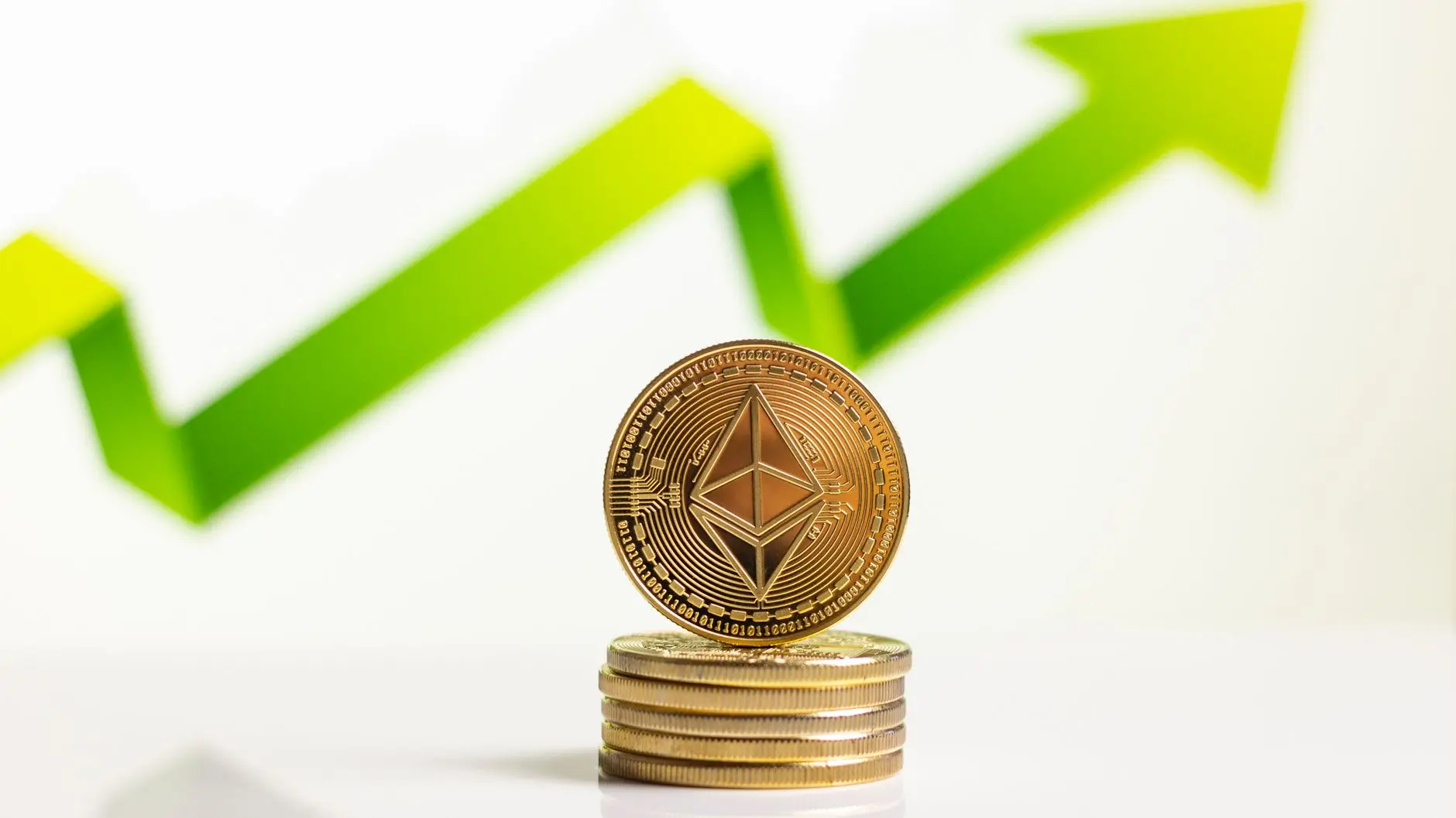 Ethereum coin stacked with a rising green graph in the background.