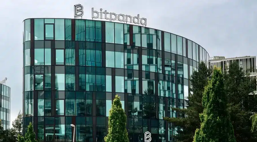 Modern glass office building with the Bitpanda logo and name on the roof