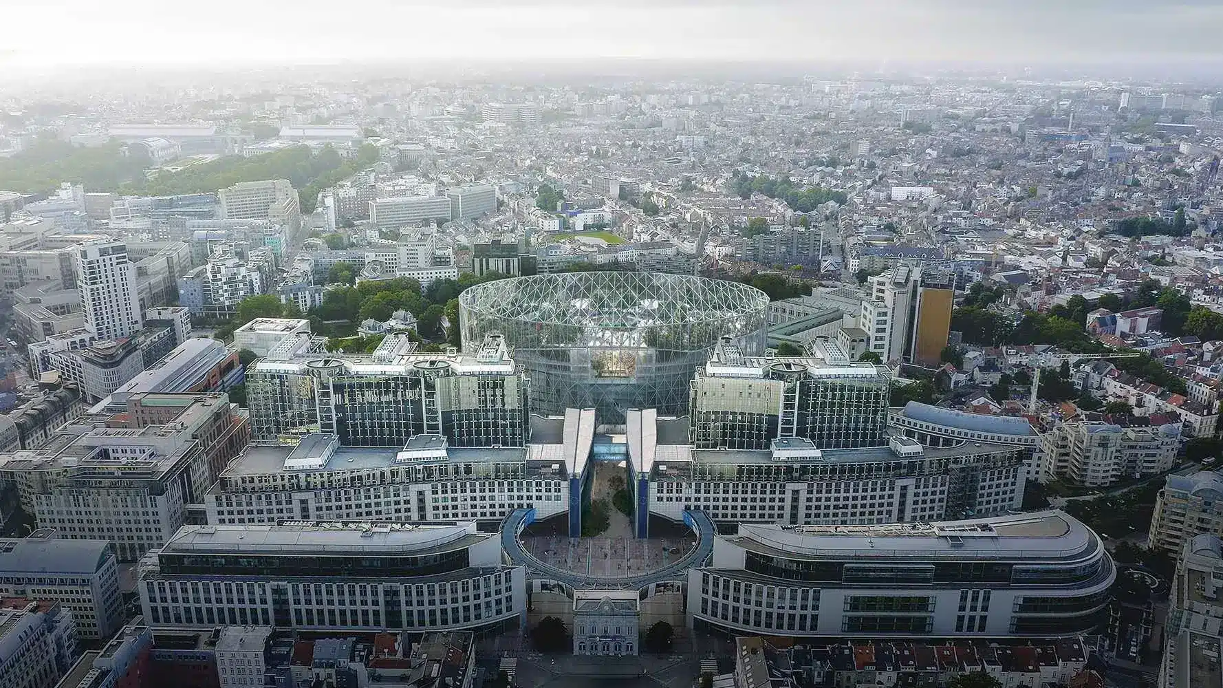 Aerial view of the European Parliament complex in Brussels featuring the glass Hemicycle dome.