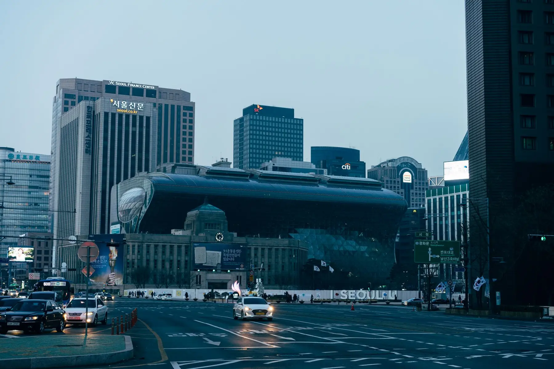 Cityscape of Seoul featuring the Seoul Finance Center and a modern curved building at dusk.