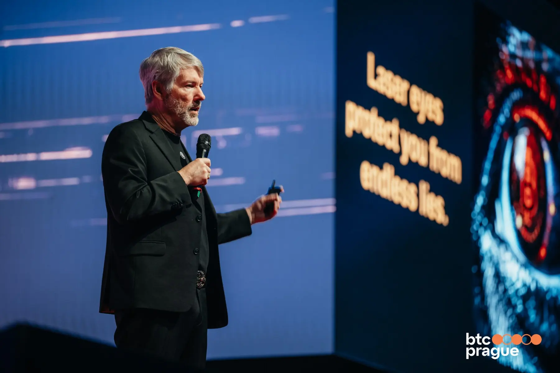Michael Saylor speaking into a microphone on stage at BTC Prague conference.