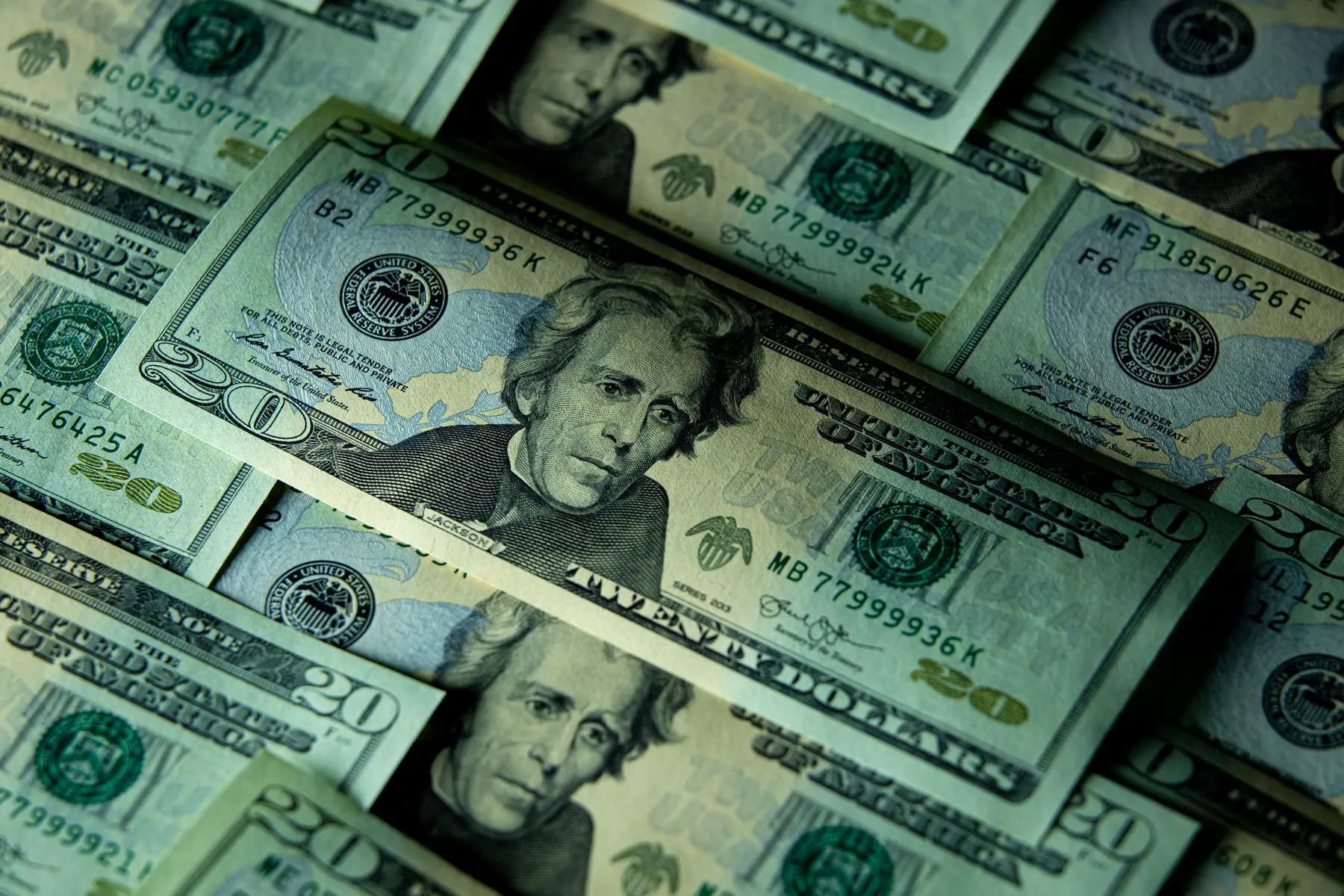 Close-up of scattered US twenty-dollar banknotes featuring Andrew Jackson