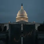 United States Capitol behind a dark barrier, symbolizing the blocked CLARITY Act debate